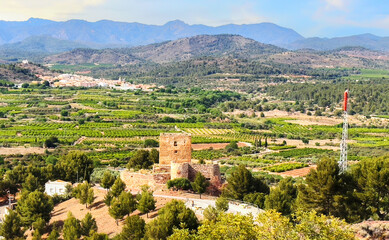 Torres-Torres town village, Valencia, Spain. Town at Mountains hills. Houses roofs in countryside. Olive farm field, Orange field. Rural landscape. Countryside at mountains. Mountains landscape