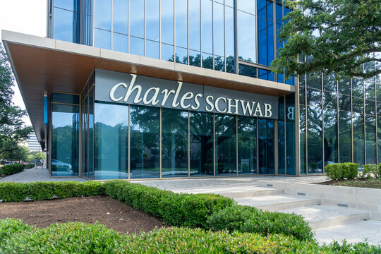 Houston, Texas, USA - April 7, 2024: Charles Schwab logo sign at one of their offices in Houston, Texas, USA. The Charles Schwab Corporation is an American multinational financial services company.