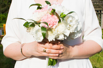 A bride holding her bouquet of flowers on her wedding day.