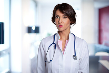 Portrait of mid aged female doctor standing at the clinic