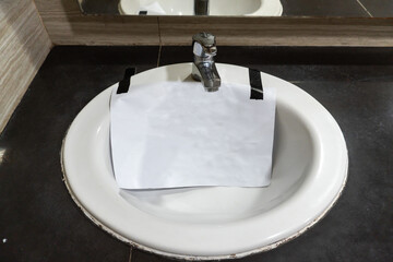 Blank sign of broken faucet under reparation