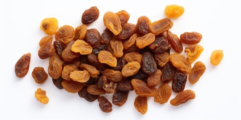 A bunch of dried fruit, including raisins and prunes, are spread out on a white background