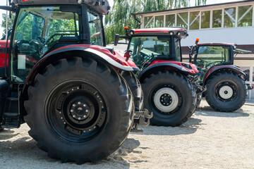 Row of red agricultural tractors for sale.