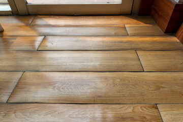 Texture of an old wooden floor with the sunlight shining through the window