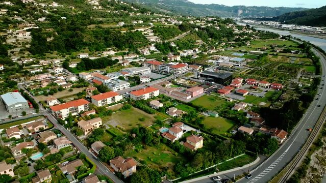 flyover on a drone from a bird's eye view of the city, river and beautiful mountains, cinematic, advertising, France Le Broc