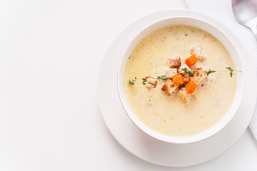 Cream soup of vegetables and cheese with croutons on a white table. A place to copy the space. Photo for a menu or banner. View from above.