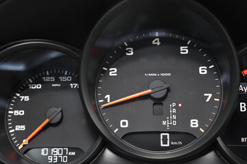 Speedometer and tachometer inside of modern car, closeup