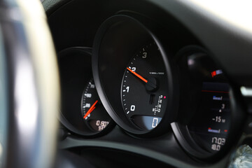 Speedometer and tachometer inside of modern car, closeup