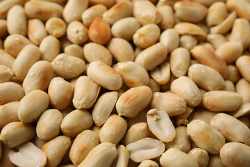 Many roasted peanuts as background, closeup view