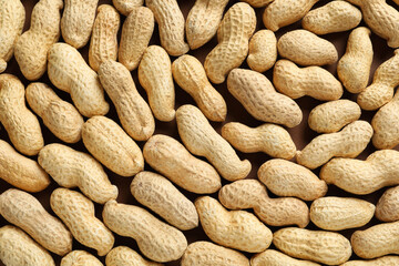 Many fresh unpeeled peanuts as background, top view