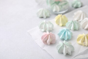 Tasty meringue cookies on light grey table, closeup. Space for text