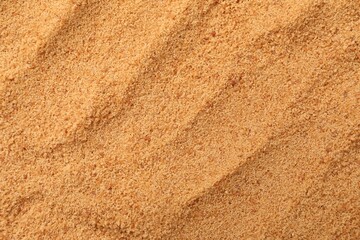 Brown coconut sugar as background, top view