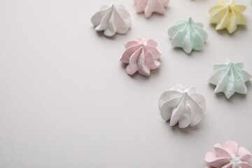 Delicious meringue cookies on light background, closeup. Space for text