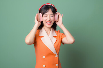 Woman in orange dress listening to music