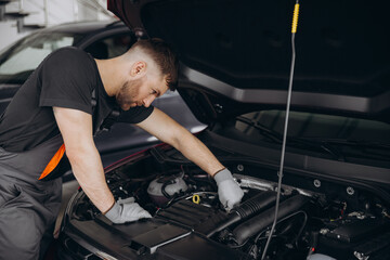 Troubleshooting process. Auto mechanic working in garage. Repair service.