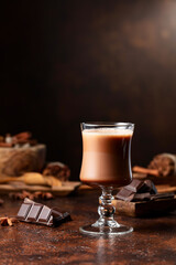  Glass of cocoa drink and pieces of dark chocolate.