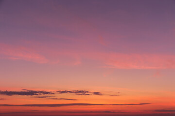 Sunrise, sunset pink violet orange sky with clouds background texture