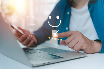 Business people touch virtual screens on the happy Smile face icon to give satisfaction in service....