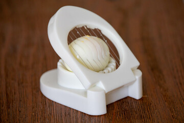 Classic egg slicer isolated on plain background