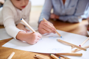 Grandma takes care of the grandchildren while their parents are at work, doing crafts, drawing on...