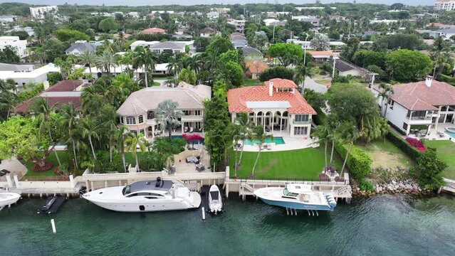 BOCA RATON, FLORIDA Aerial footage of the upscale coastal community in Boca Raton, Florida, highlighting luxurious waterfront homes, high-rise condominiums, and commercial buildings.