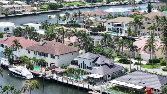 BOCA RATON, FLORIDA Aerial footage of the upscale coastal community in Boca Raton, Florida, highlighting luxurious waterfront homes, high-rise condominiums, and commercial buildings.