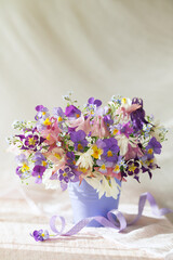 Still life with a bouquet of spring and summer blue, pink, white and purple flowers, columbine,...