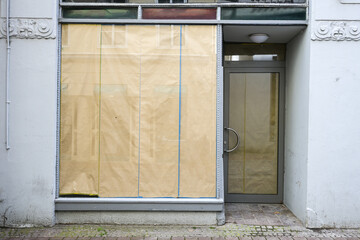 Closed store with paper-covered shop window, insolvencies and vacancies in the city center due to...