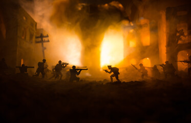 Conceptual image of war between Democracy and dictatorship using toy soldiers. Battle in ruined city.