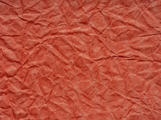 Crimson crinkles dance across the textured landscape of this paper