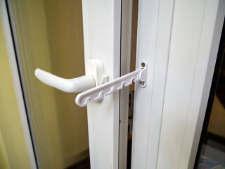 Opening limiter installed on a plastic window
