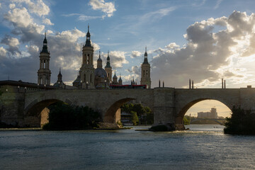 Naklejka premium Ebro river, Roman bridge and Pilar at sunset in Zaragoza, Aragon, Spain. 