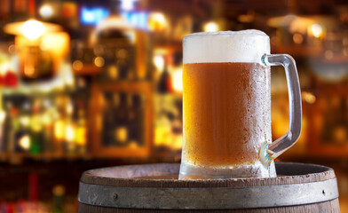 Mug of beer in a bar on wooden barrel