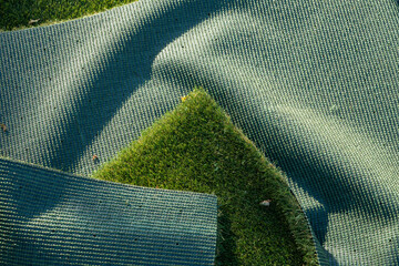 both sides of Artificial turf mats being installed on a soccer field