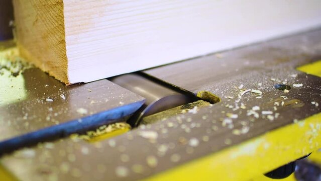 Electric jointer during operation. Wood board processing. Close-up. Slow motion FHD footage.