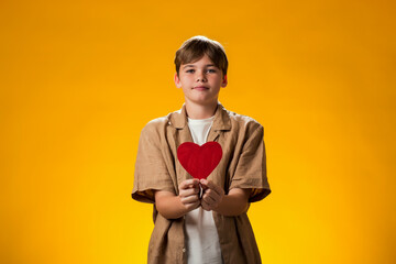 Boy holding paper heart. Love and valentine day and gratitude concept © Aleksej