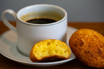 Afternoon coffee served in a white cup with cornbread or cheese bread