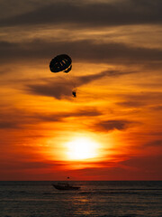 Parasailing Adventure at Sunset Over the Ocean
