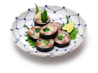 A Japanese sushi restaurant roll dish of pickled sardines and ginger wrapped in nori seaweed.