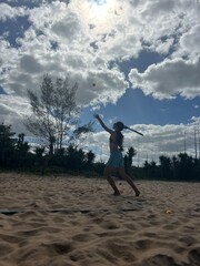 girl playing beach tennis on the beach