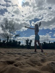 girl playing beach tennis on the beach