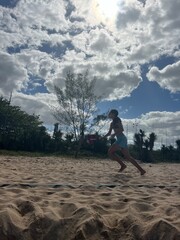 girl playing beach tennis on the beach