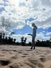 girl playing beach tennis on the beach