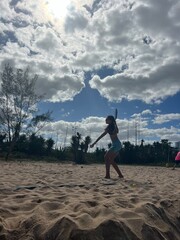 girl playing beach tennis on the beach