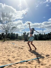 girl playing beach tennis on the beach