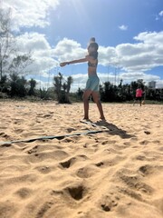 girl playing beach tennis on the beach