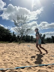 girl playing beach tennis on the beach