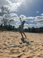 girl playing beach tennis on the beach