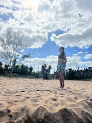 girl playing beach tennis on the beach