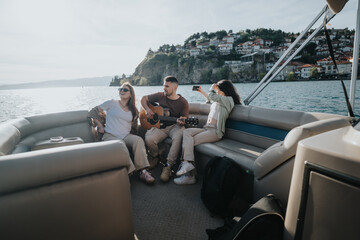 Three friends enjoy a serene boat ride by the coastal town, with one playing the guitar and another...